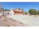 Charming two-story home boasting a three-car garage, mature tree, and desert landscaping at 1634 Georgia Ave, Boulder City, NV 89005