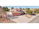 Charming two-story home with three-car garage and iron gate, complemented by desert landscaping and a spacious driveway at 1634 Georgia Ave, Boulder City, NV 89005