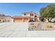 Charming two-story home featuring a three-car garage, landscaped yard, and desert landscaping at 1634 Georgia Ave, Boulder City, NV 89005