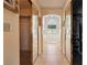 Hallway with tile flooring, mirrored closet doors, and an arched window above a bathtub in the background at 1634 Georgia Ave, Boulder City, NV 89005