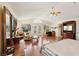 Spacious living room with hardwood floors, a ceiling fan, and a view of the outside through the windows and doors at 1634 Georgia Ave, Boulder City, NV 89005