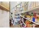 Walk-in pantry with shelves stocked with food and kitchen supplies at 1634 Georgia Ave, Boulder City, NV 89005