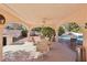 Inviting covered patio with ceiling fan, dining set, outdoor kitchen, and refreshing pool at 1634 Georgia Ave, Boulder City, NV 89005