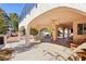 Spacious covered patio with ceiling fans, lounge chairs, and an outdoor dining area for entertaining guests at 1634 Georgia Ave, Boulder City, NV 89005