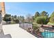 Wide view from a spacious patio overlooking mature trees, blue skies, and a sparkling blue pool at 1634 Georgia Ave, Boulder City, NV 89005