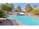 Inviting swimming pool with waterfall feature and lush landscaping for a relaxing backyard retreat at 1634 Georgia Ave, Boulder City, NV 89005