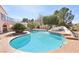 Inviting backyard pool and spa with lush palm trees and mature trees creating a private outdoor sanctuary at 1634 Georgia Ave, Boulder City, NV 89005