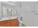 Well-lit bathroom featuring a single sink vanity, a toilet, and a large mirror at 1830 N Buffalo Dr # 1029, Las Vegas, NV 89128
