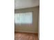 Bright bedroom features a large window with wood laminate flooring at 1842 N Decatur Blvd # 101, Las Vegas, NV 89108