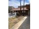 Exterior shot of back of condo, with tiled roof, fenced patio, and landscaping at 1842 N Decatur Blvd # 101, Las Vegas, NV 89108