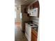 Kitchen with white appliances, granite countertops, and wood cabinets at 1842 N Decatur Blvd # 101, Las Vegas, NV 89108