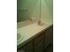 A primary bathroom with a double sink vanity, with a white tile countertop and wood cabinets at 1851 Hillpointe Rd # 2112, Henderson, NV 89074