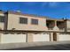 A bright exterior view shows the garages and balcony of this multi-Gathering home at 1851 Hillpointe Rd # 2112, Henderson, NV 89074