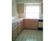 The kitchen features tiled floors, wooden cabinets, and white countertops, creating a clean design at 1851 Hillpointe Rd # 2112, Henderson, NV 89074