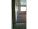The living room has brown carpeting, white walls, a large window, and a view of the entry at 1851 Hillpointe Rd # 2112, Henderson, NV 89074