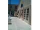 This is a view of the side of the community building and lounge chairs around the pool at 1851 Hillpointe Rd # 2112, Henderson, NV 89074