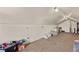 Finished attic with a window, carpet, angled ceiling, chair, shelving and toys at 1951 Jim Haworth Ct, Logandale, NV 89021