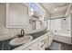 Main bathroom featuring double sinks, vanity lighting, tile counters and floors and a soaking tub at 1951 Jim Haworth Ct, Logandale, NV 89021