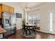 Eat-in kitchen features stainless steel appliances, a dining table, and hard wood floors at 1951 Jim Haworth Ct, Logandale, NV 89021