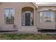 Arched front entrance of the house with decorative steps and a large front window at 1951 Jim Haworth Ct, Logandale, NV 89021