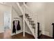 Hallway with a staircase, coat rack, and view into a bathroom with a white shower curtain at 1951 Jim Haworth Ct, Logandale, NV 89021