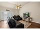This living room features hard wood floors, a ceiling fan and a large tv at 1951 Jim Haworth Ct, Logandale, NV 89021