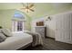 Main bedroom featuring vaulted ceiling, arched window, wood floors, and a decorative ceiling fan at 1951 Jim Haworth Ct, Logandale, NV 89021
