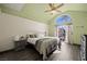 Main bedroom with a vaulted ceiling, transom window, ceiling fan, wood floors and dresser at 1951 Jim Haworth Ct, Logandale, NV 89021