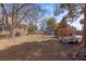 Large backyard with utility trailer, storage containers and mature trees at 1951 Jim Haworth Ct, Logandale, NV 89021