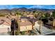 Aerial view showcases a home with solar panels, palm trees, and mountain backdrop at 2140 Idaho Falls Dr, Henderson, NV 89044