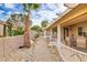 Lush backyard area with covered patio, mature trees, and stone landscaping at 2140 Idaho Falls Dr, Henderson, NV 89044