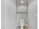 Modern bathroom featuring a white toilet, gray cabinets, and neutral wall paint at 2140 Idaho Falls Dr, Henderson, NV 89044