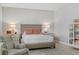 Comfortable bedroom features a cozy armchair and a well-lit bed, creating a relaxing retreat at 2140 Idaho Falls Dr, Henderson, NV 89044