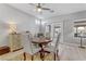 Cozy dining room features a round wood table, upholstered chairs, and a charming vintage-style dresser at 2140 Idaho Falls Dr, Henderson, NV 89044