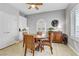 Cozy dining area with a round wooden table and seating for four, complemented by a charming buffet at 2140 Idaho Falls Dr, Henderson, NV 89044