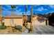 Charming home exterior with a two-car garage, and a lush landscaped front yard at 2140 Idaho Falls Dr, Henderson, NV 89044