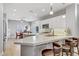 Modern kitchen featuring stone countertops, a kitchen island with seating, and stainless steel appliances at 2140 Idaho Falls Dr, Henderson, NV 89044