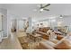 Open-concept living room with a large sectional sofa, hardwood floors, and plentiful natural light at 2140 Idaho Falls Dr, Henderson, NV 89044