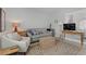 Inviting living room with a sofa, armchair, and a woven coffee table at 2140 Idaho Falls Dr, Henderson, NV 89044