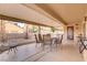Charming covered patio with neutral tones, offering a relaxing outdoor space with comfortable seating arrangement at 2140 Idaho Falls Dr, Henderson, NV 89044