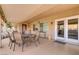Cozy covered patio with tiled floor and ample seating that connects seamlessly with the interior through glass doors at 2140 Idaho Falls Dr, Henderson, NV 89044