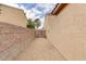 Narrow side yard featuring gravel landscaping and a block wall for privacy at 2140 Idaho Falls Dr, Henderson, NV 89044