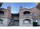 Exterior shot of the complex featuring archways, stairs, and desert landscaping at 221 Mission Catalina Ln # 202, Las Vegas, NV 89107