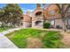 This exterior view shows a multi-story condo building featuring stairs and a well-maintained lawn at 221 Mission Catalina Ln # 202, Las Vegas, NV 89107