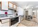 Open-concept kitchen with dining area, white appliances, and access to a pantry and storage at 221 Mission Catalina Ln # 202, Las Vegas, NV 89107