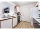 Standard kitchen with white cabinets and appliances, plenty of storage, and tile flooring at 221 Mission Catalina Ln # 202, Las Vegas, NV 89107