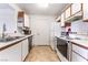 Efficient kitchen layout with white cabinetry, neutral flooring, and modern appliances at 221 Mission Catalina Ln # 202, Las Vegas, NV 89107
