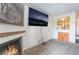 Cozy living room featuring a brick fireplace, plush carpet, and a flatscreen TV at 221 Mission Catalina Ln # 202, Las Vegas, NV 89107