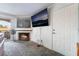 Living room with a fireplace, flatscreen television, and access to balcony area at 221 Mission Catalina Ln # 202, Las Vegas, NV 89107