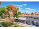Organized parking area with covered spaces, ample greenery, and easy access to the building, ensuring convenient and secure parking at 221 Mission Catalina Ln # 202, Las Vegas, NV 89107